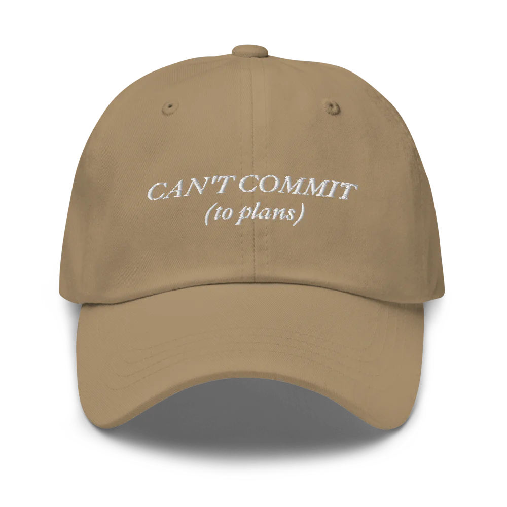 brown cap with text 'CAN'T COMMIT (to plans)' embroidered in white on a white background