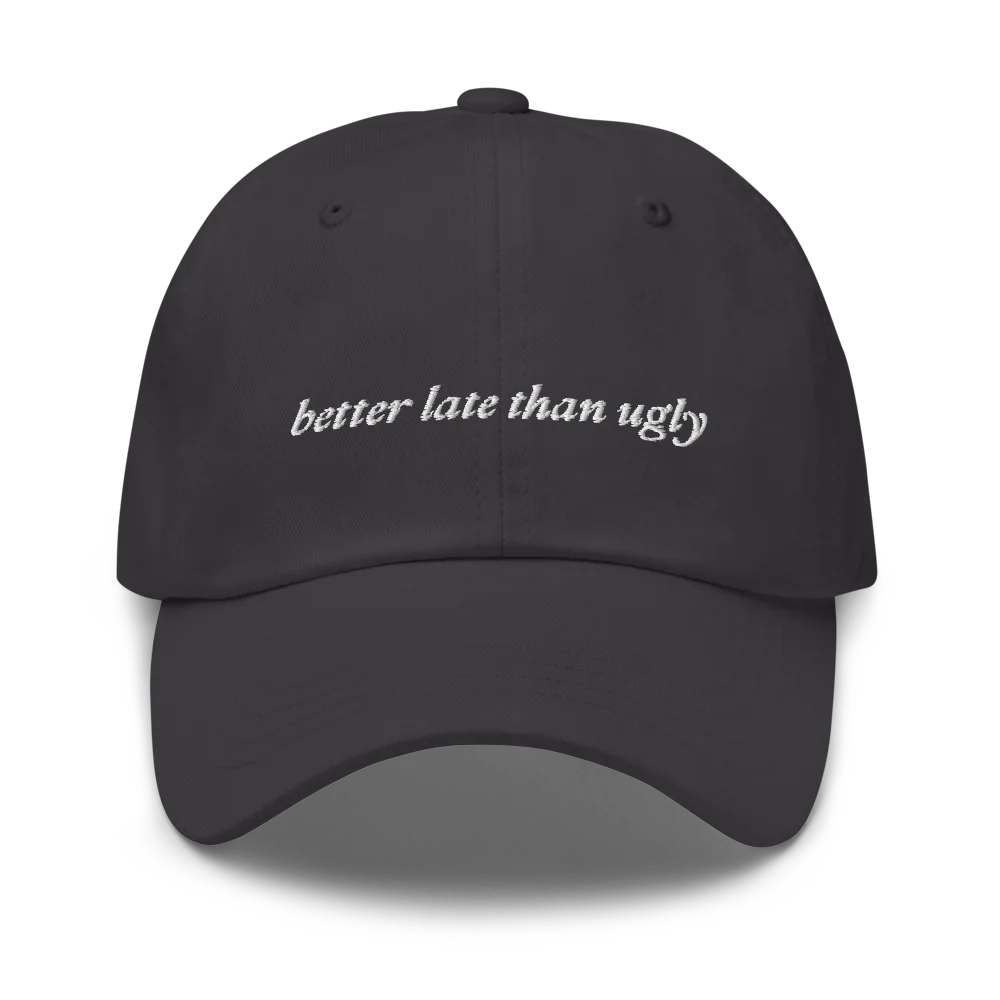 gray baseball hat with 'better late than ugly' text embroidered in white on a white background
