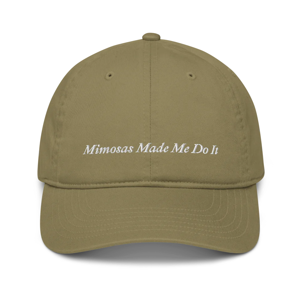 green baseball hat with 'Mimosas Made Me Do It' embroidered text on a white background