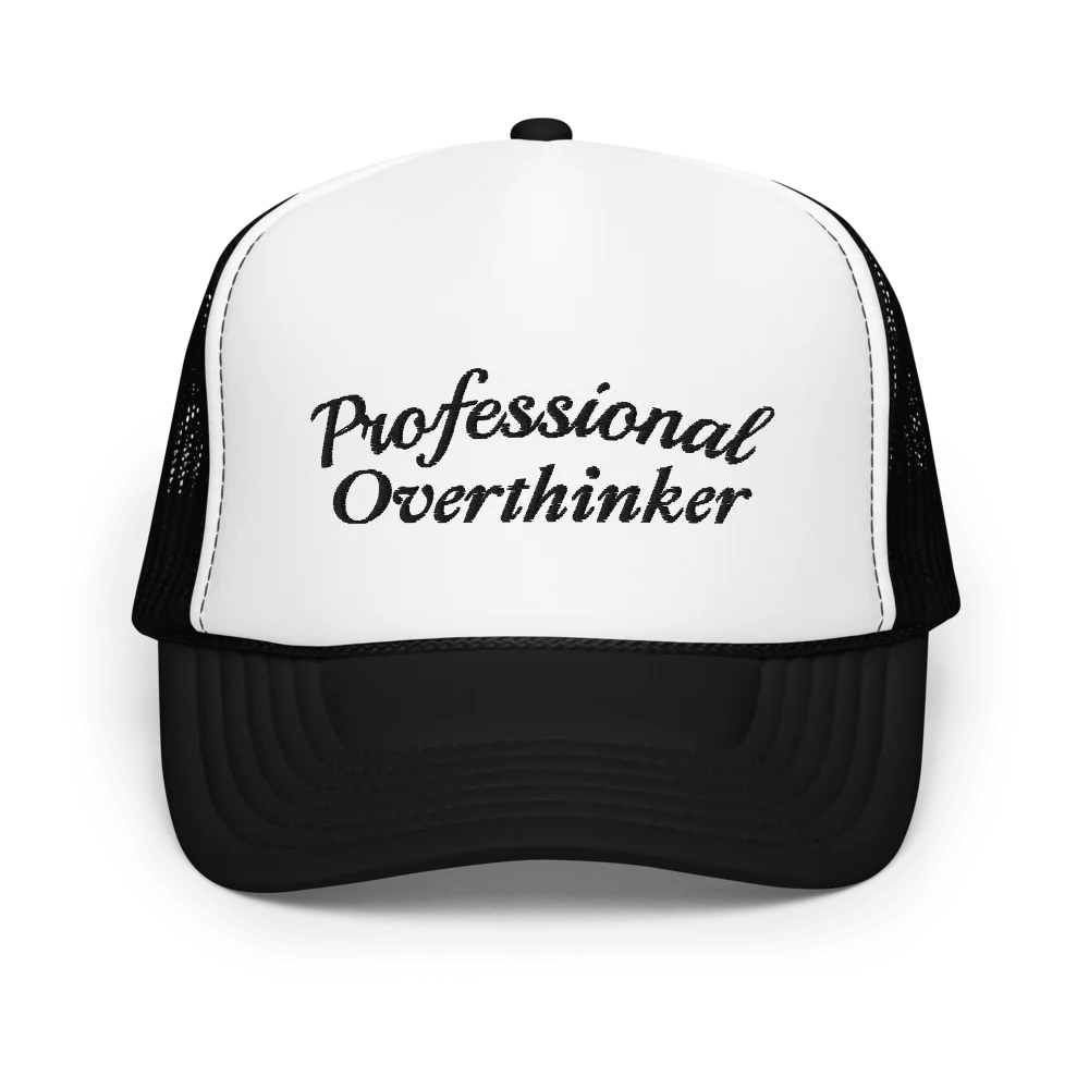 Black and white trucker hat with 'Professional Overthinker' text on a white background
