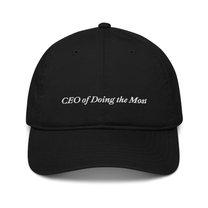 Black baseball hat with 'CEO of Doing the Most' text embroidered in white on a white background