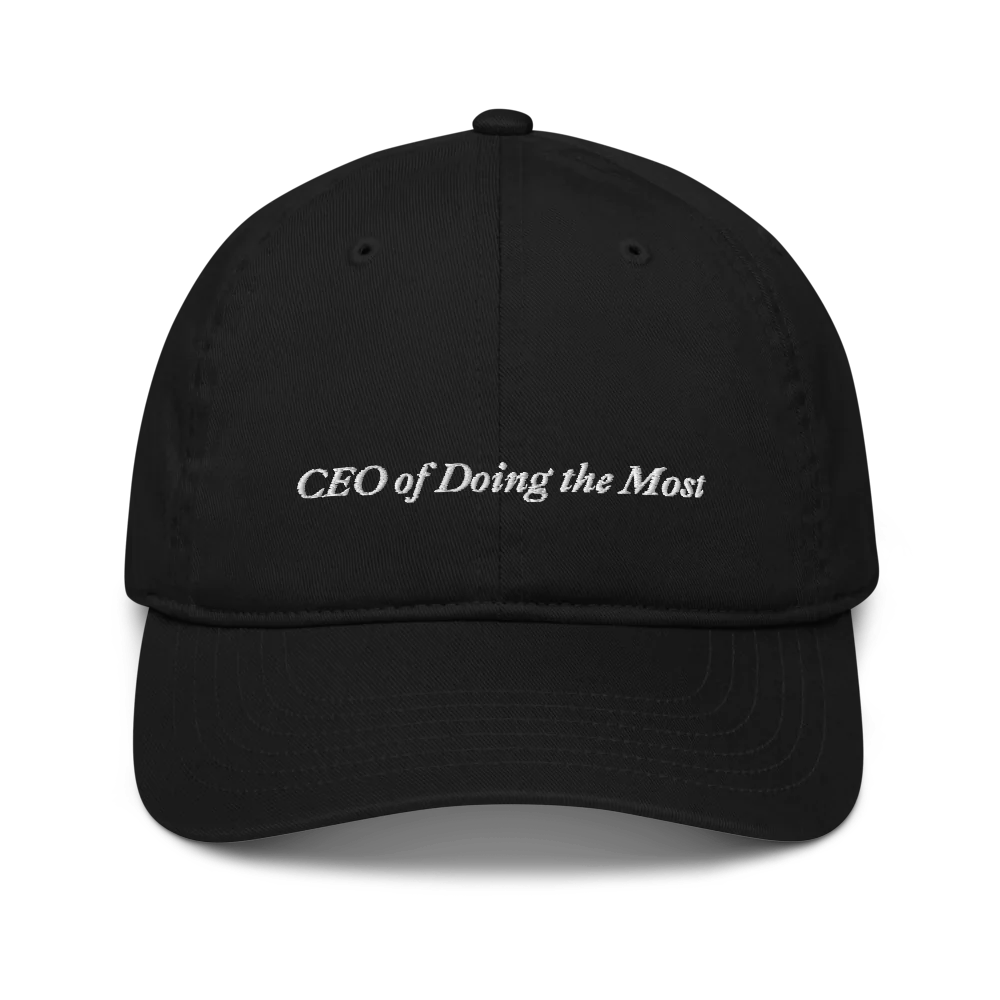 Black baseball hat with 'CEO of Doing the Most' text embroidered in white on a white background
