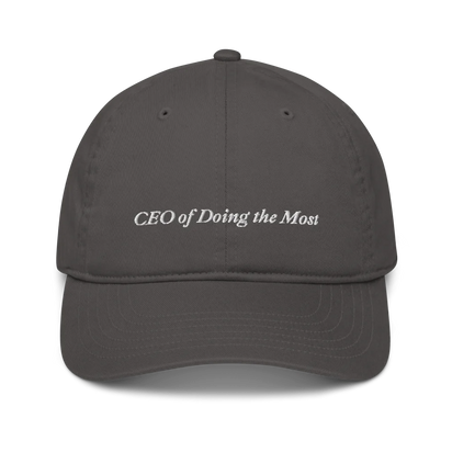 Gray baseball hat with 'CEO of Doing the Most' text embroidered in white on a white background