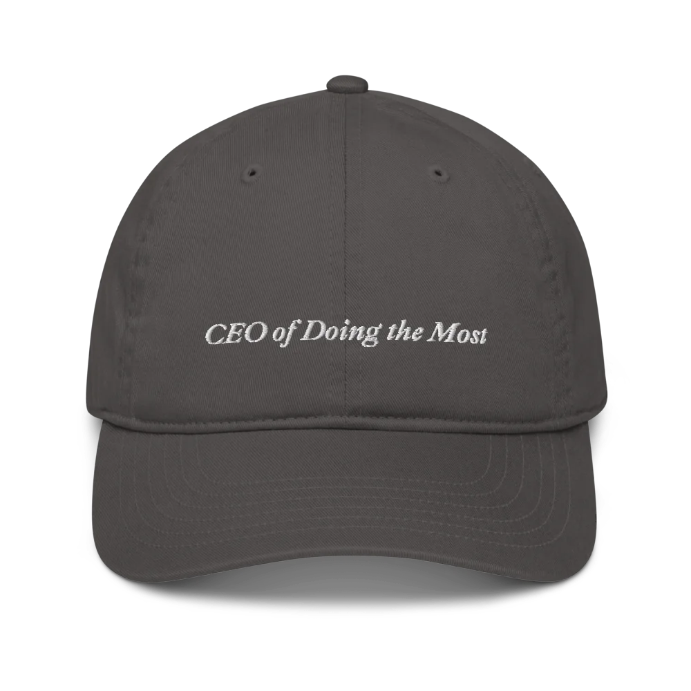 Gray baseball hat with 'CEO of Doing the Most' text embroidered in white on a white background