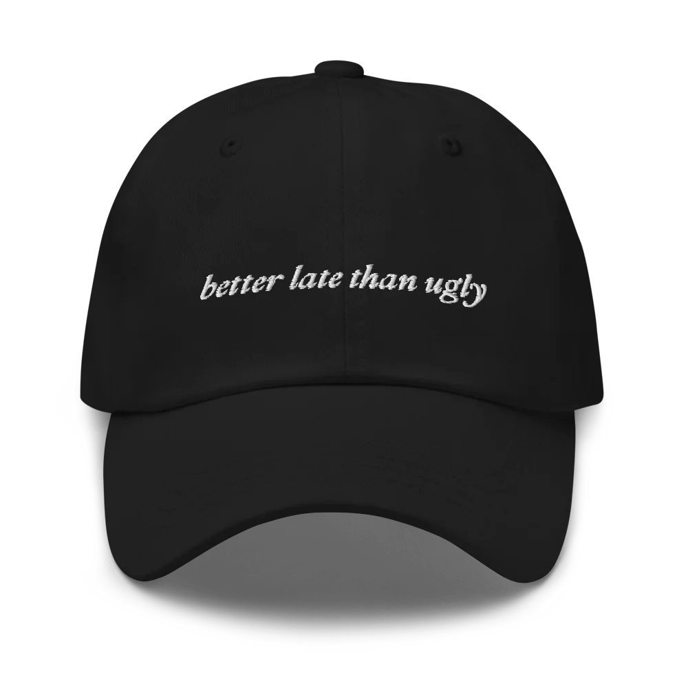 Black baseball hat with 'better late than ugly' text embroidered in white on a white background
