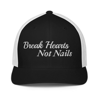 Black and white trucker hat with 'Break Hearts Not Nails' text embroidered in white on a white background