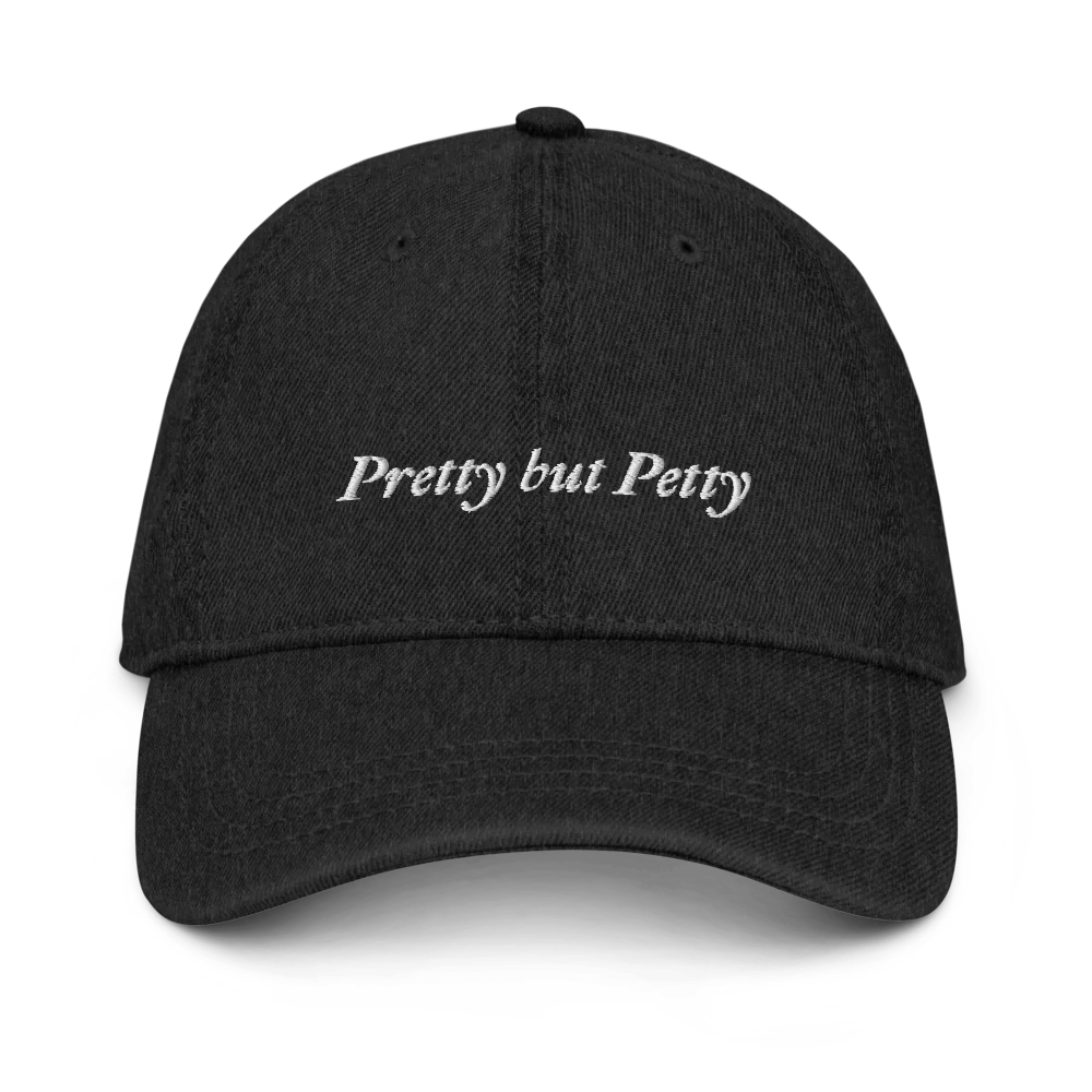 Black Denim baseball hat with 'Pretty but Petty' text embroidered in white on a white background