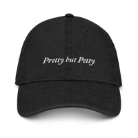 Black Denim baseball hat with 'Pretty but Petty' text embroidered in white on a white background