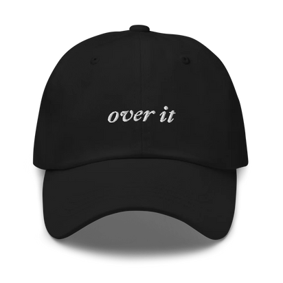 black baseball hat with 'over it' text embroidered in white on a white background