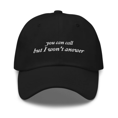 Black baseball hat with white embroidered text 'you can call but I won't answer' on a white background