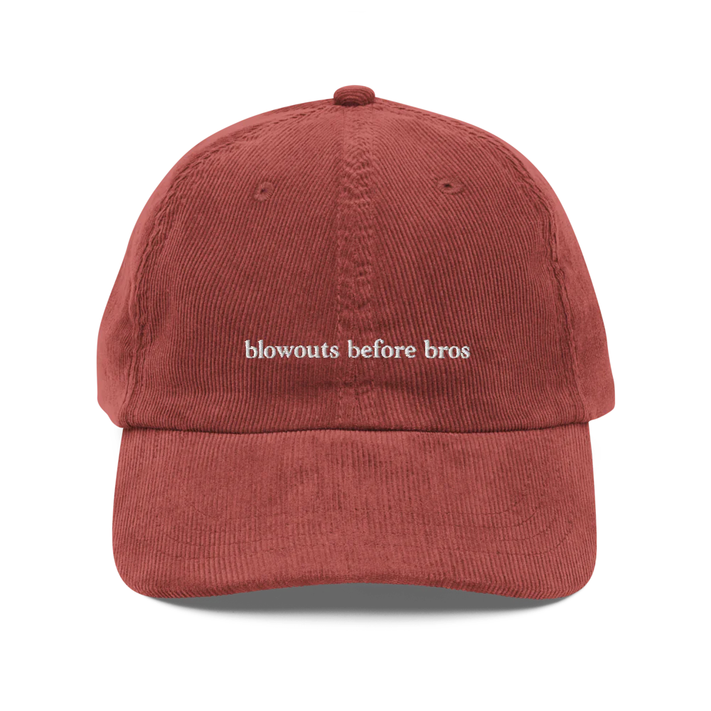 Red corduroy baseball hat with 'blowouts before bros' text embroidered in white on a white background
