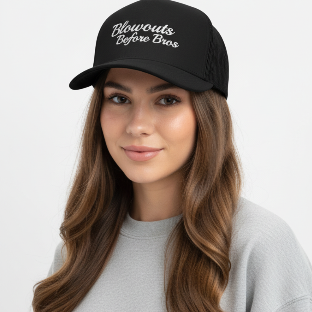 girl wearing black trucker hat with 'Blowouts Before Bros' text embroidered in white on a white background