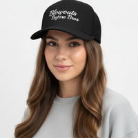 girl wearing black trucker hat with 'Blowouts Before Bros' text embroidered in white on a white background