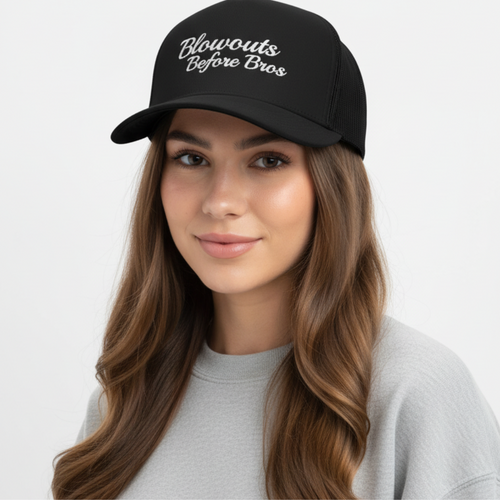 girl wearing black trucker hat with 'Blowouts Before Bros' text embroidered in white on a white background