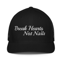 Black trucker hat with 'Break Hearts Not Nails' text embroidered in white on a white background