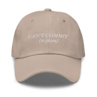 beige cap with text 'CAN'T COMMIT (to plans)' embroidered in white on a white background