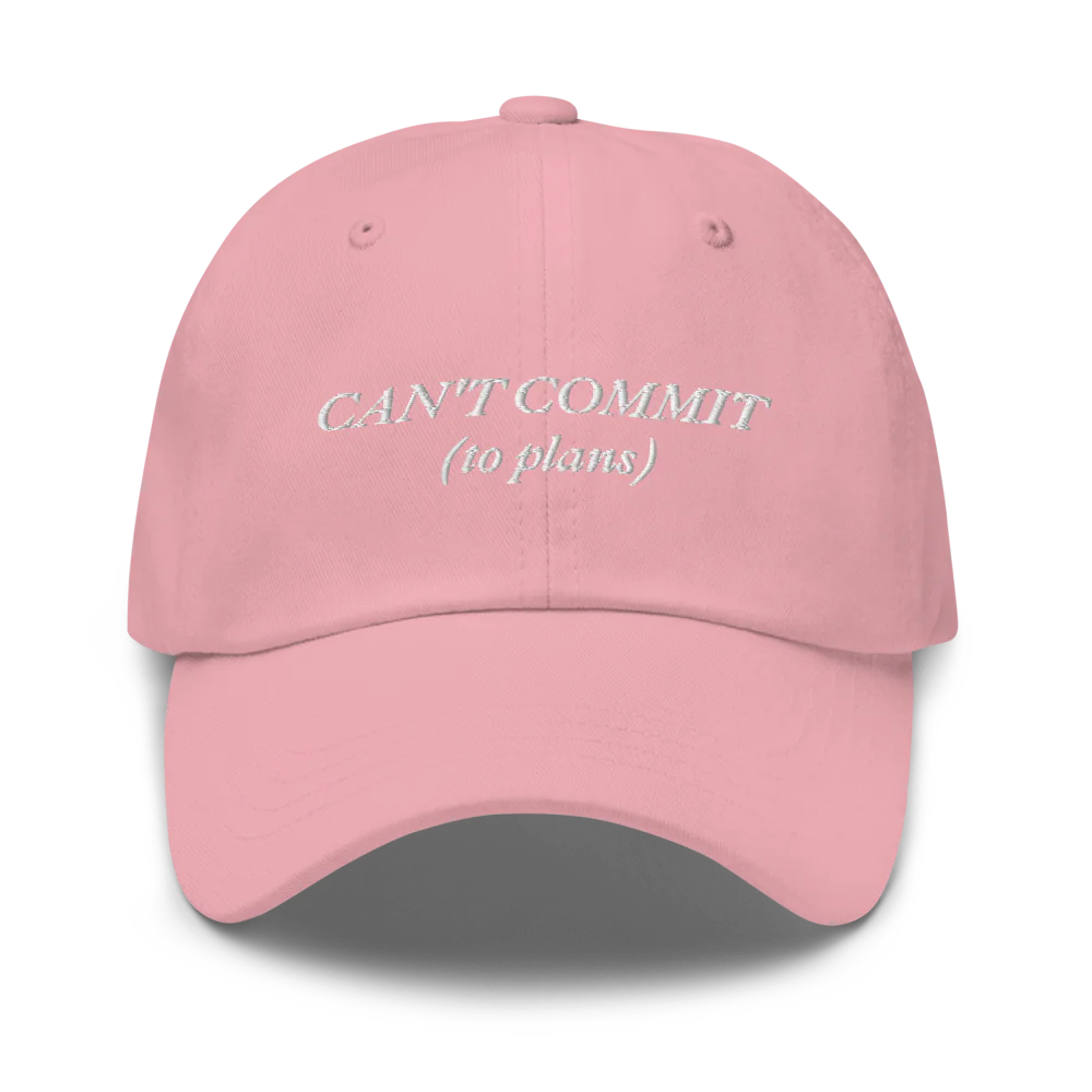 pink cap with text 'CAN'T COMMIT (to plans)' embroidered in white on a white background