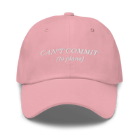 pink cap with text 'CAN'T COMMIT (to plans)' embroidered in white on a white background