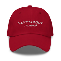red cap with text 'CAN'T COMMIT (to plans)' embroidered in white on a white background