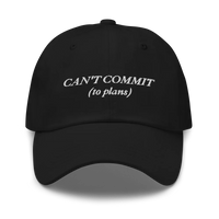 Black cap with text 'CAN'T COMMIT (to plans)' embroidered in white on a white background