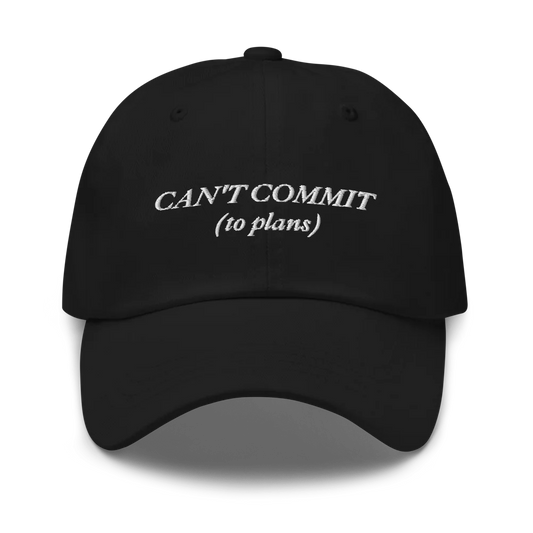 Black cap with text 'CAN'T COMMIT (to plans)' embroidered in white on a white background