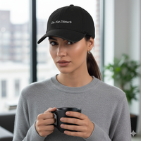 Girl Wearing Black denim baseball hat with 'Do Not Disturb' text embroidered in white on a white background