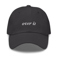 Gray baseball hat with 'over it' text embroidered in white on a white background
