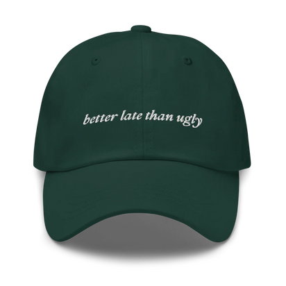 green baseball hat with 'better late than ugly' text embroidered in white on a white background