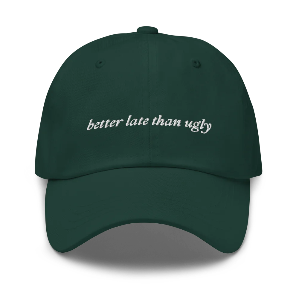 green baseball hat with 'better late than ugly' text embroidered in white on a white background