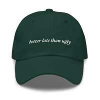 green baseball hat with 'better late than ugly' text embroidered in white on a white background