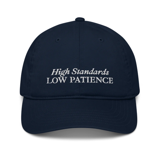 Navy Blue cap with 'High Standards Low Patience' text embroidered in white on a white background