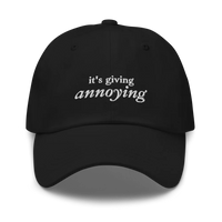 black baseball hat with white text 'it's giving annoying' embroidered on front