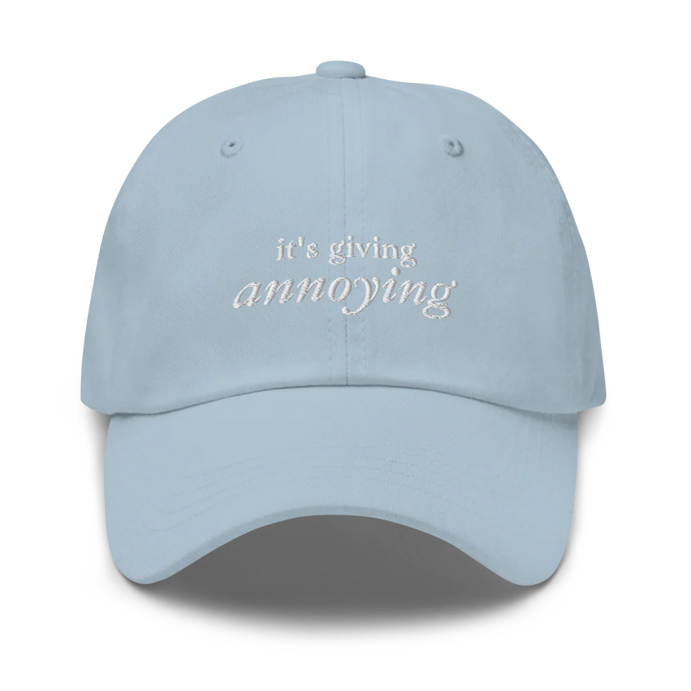 Light Blue baseball hat with white text 'it's giving annoying' embroidered on front