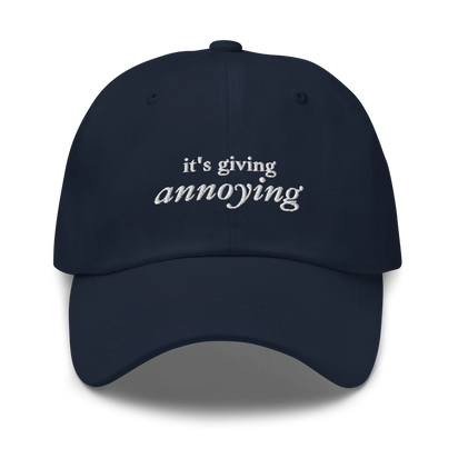 Navy baseball hat with white text 'it's giving annoying' embroidered on front