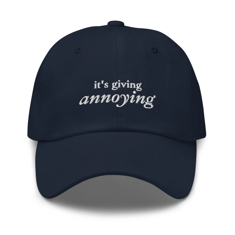 Navy baseball hat with white text 'it's giving annoying' embroidered on front