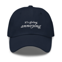 Navy baseball hat with white text 'it's giving annoying' embroidered on front
