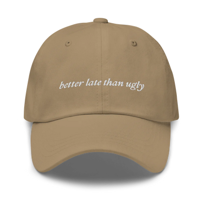 khaki baseball hat with 'better late than ugly' text embroidered in white on a white background