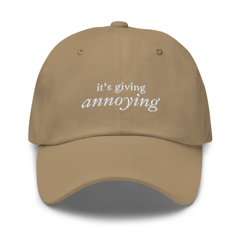 khaki baseball hat with white text 'it's giving annoying' embroidered on front