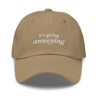 khaki baseball hat with white text 'it's giving annoying' embroidered on front