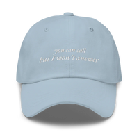 Light Blue baseball hat with white embroidered text 'you can call but I won't answer' on a white background