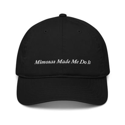 black baseball hat with 'Mimosas Made Me Do It' embroidered text on a white background