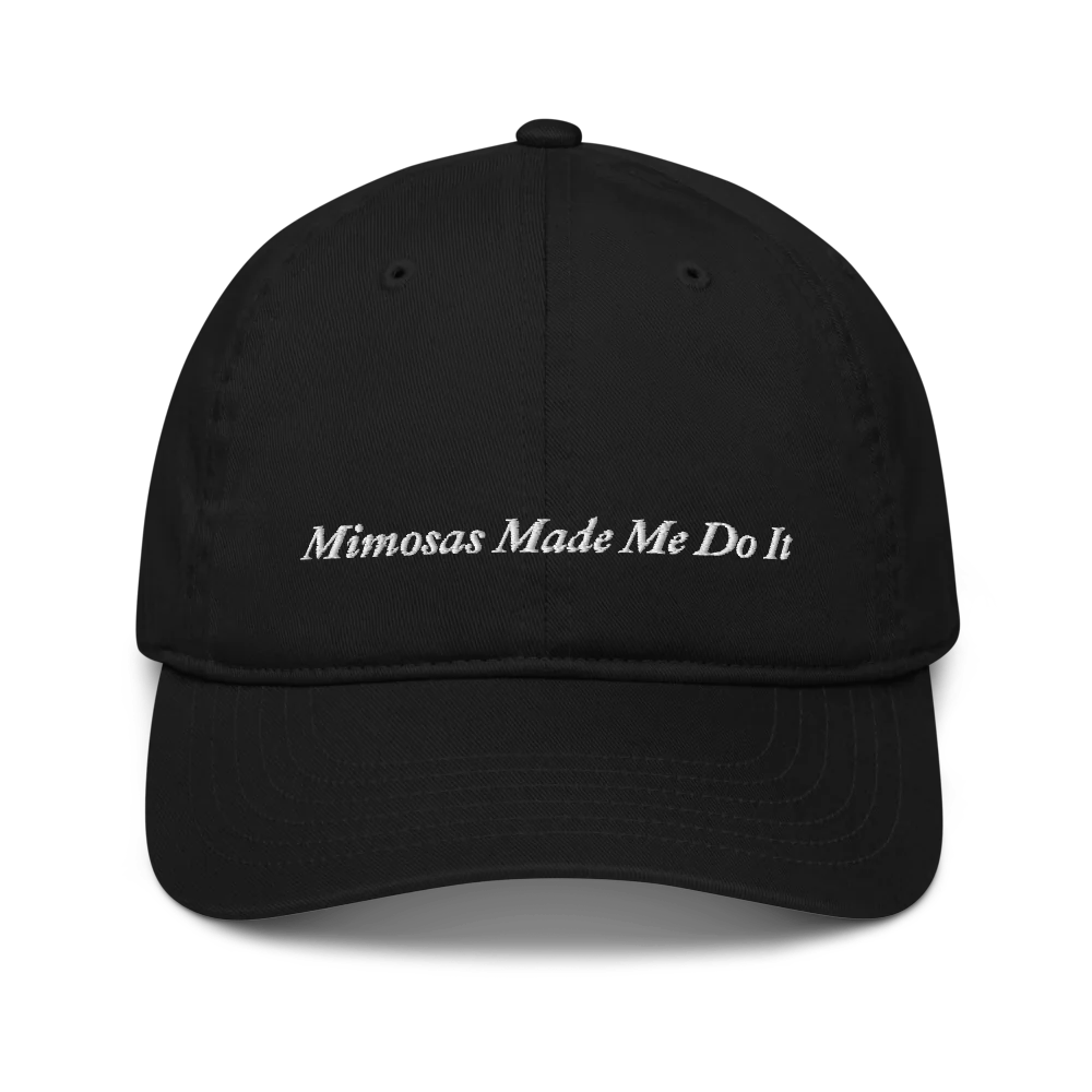 black baseball hat with 'Mimosas Made Me Do It' embroidered text on a white background