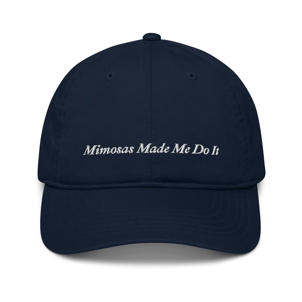 navy blue baseball hat with 'Mimosas Made Me Do It' embroidered text on a white background