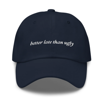 navy baseball hat with 'better late than ugly' text embroidered in white on a white background