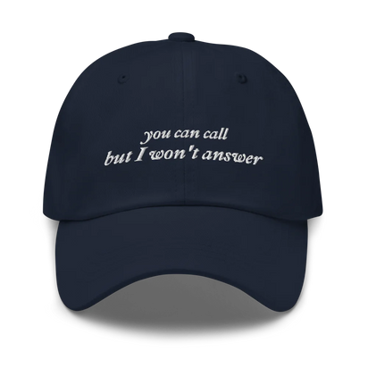 Navy Blue baseball hat with white embroidered text 'you can call but I won't answer' on a white background