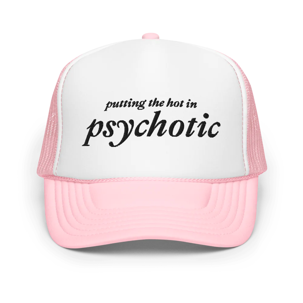 Pink and white trucker hat with embroidered black text that says "putting the hot in psychotic"