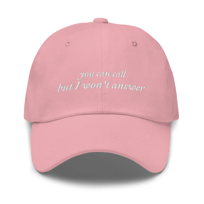 pink baseball hat with white embroidered text 'you can call but I won't answer' on a white background