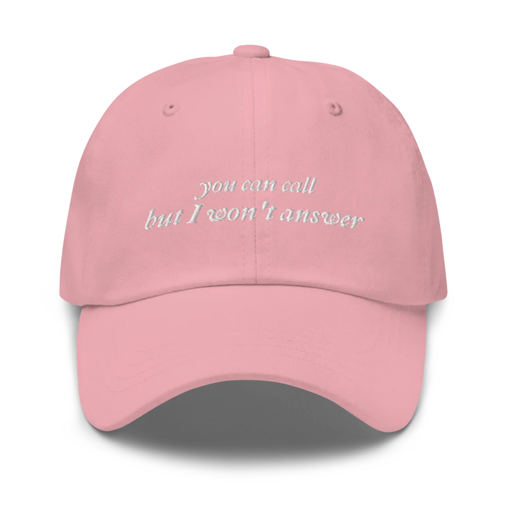 pink baseball hat with white embroidered text 'you can call but I won't answer' on a white background