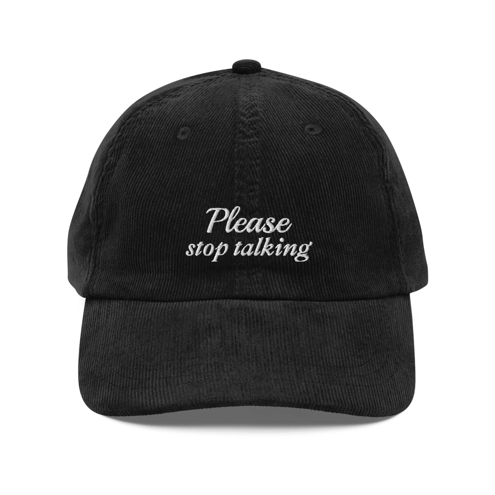 black corduroy baseball hat with "Please stop talking" embroidered in white.