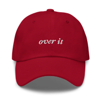 red baseball hat with 'over it' text embroidered in white on a white background